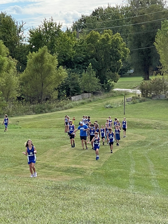 group of students run cross-country